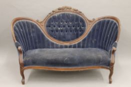 A Victorian mahogany carved arch back settee. Approximately 165 cm long.