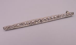 An Edwardian platinum twenty-one diamond bar brooch. Approximately 1.5 carats of diamonds. 7.