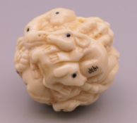 A bone ball carved with animals. Approximately 3.5 cm.