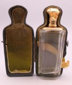 A boxed 18 ct gold topped scent bottle. 9 cm high.