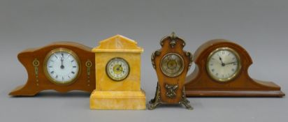 Four various mantle clocks. The largest 35 cm wide.