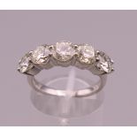 A platinum five stone diamond ring. Approximately 2.65 total carat weight. Ring size M.