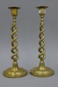 A pair of antique brass barley twist candlesticks. 31 cm high.
