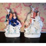 Two C19th Staffordshire clock figures of a Scott and his lass decorated in different colour ways,