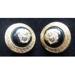 Pair of Gianni Versace gold plated earrings with Versace logo on black semi spherical mount with