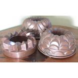 Three early C20th circular copper jelly moulds, smallest stamped "J.L.M 346," max D22cm and a pair