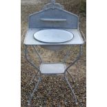 Early C20th metal washstand with splash back and floral design, complete with enamel bowl, H110cm