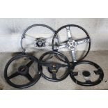 Three spoke steering wheel with Morgan boss, two other three spoke steering wheels with Momo bosses,