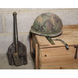 American M6 helmet with camouflage covering, possibly 1960s, and a entrenching tool with leather and