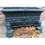 Cast iron rectangular jardiniere, the body cast with mask heads and scroll work with lotus cast rim,