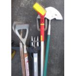 Collection of garden tools including Fiskars weed puller, lawn hedger, long handled fork, etc