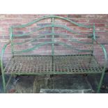 Regency style green painted metal strapwork garden seat with arched back and down scroll arms,