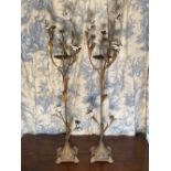 Pair of gilt metal and ceramic pricket candle sticks with white flowerheads on slender