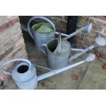 Galvanised watering can with 1 1/2gl plaque, two others marked 10 and 13, max L75cm (3)