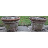 Pair of large terracotta garden pots, circular tapering bodies with reeded decoration and rolled