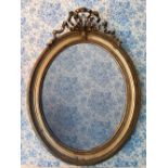Large C20th wall mirror, upright oval plate in giltwood and gesso bead and lotus moulded frame, with