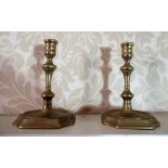 Pair of C18th cast brass candlesticks with spool shaped sconces on slender single knop column, the