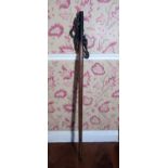 Early C20th cast metal cattle leading hook, turned oak handle with dot prick decoration, L127cm