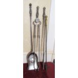 Set of three Regency style polished steel fire implements, plain shafts with lobed urn shaped