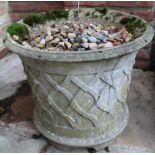 Pair of weathered composition planters, circular tapering bodies relief decorated with