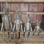 Graduated set of four articulated and painted carved wooden models of hares, max H70cm (4)