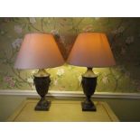 Pair of Regency toleware style table lamps, urn shaped bodies with lion mask and ring handles on