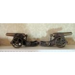 Pair of C20th brass and cast metal models of field guns, tapering adjustable barrels on scroll