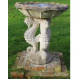 Regency Revival composite bird bath, waved edge circular top on three seahorse supports and