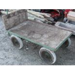 Four wheeled metal hand trolley, wooden base with pneumatic tyres