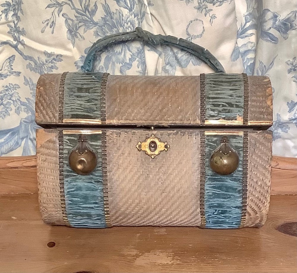 French basket weave dome topped jewellery box with two blue silk bands with brass bosses, ribbon