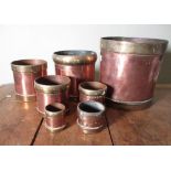 Graduated set of seven brass bound copper 2 Seer to 1/32 Seer cylindrical measures, stamped The