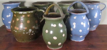 Collection of C20th rustic pottery dairy jugs, decorated with cream polka dots on blue and green