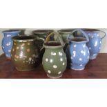 Collection of C20th rustic pottery dairy jugs, decorated with cream polka dots on blue and green