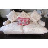 George Smith Standard sofa, with serpentine back and scroll arms on turned supports with brass