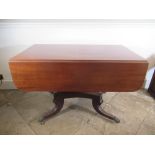 Regency mahogany pedestal Pembroke table, with end drawer and two fall leaves on angular baluster