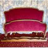 C20th walnut framed double bedstead, with serpentine moulded head and curved foot boards brass