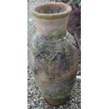 Large ribbed terracotta olive jar barrel, circular tapering body with undulating shoulders and