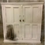 C20th painted pine school type cupboard with moulded cornice above two four panelled doors, on a