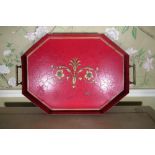 Regency style red toleware octagonal galleried tray, decorated to centre with gilt scroll work,