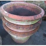 Set of three terracotta garden pots, circular tapering form with rolled rims, D59cm H43cm