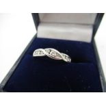 Hallmarked 9ct white gold twisted infinity ring inset with a central diamond flanked by four smaller