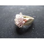 14ct yellow gold cluster ring with central round cut diamond surrounded by smaller round cut