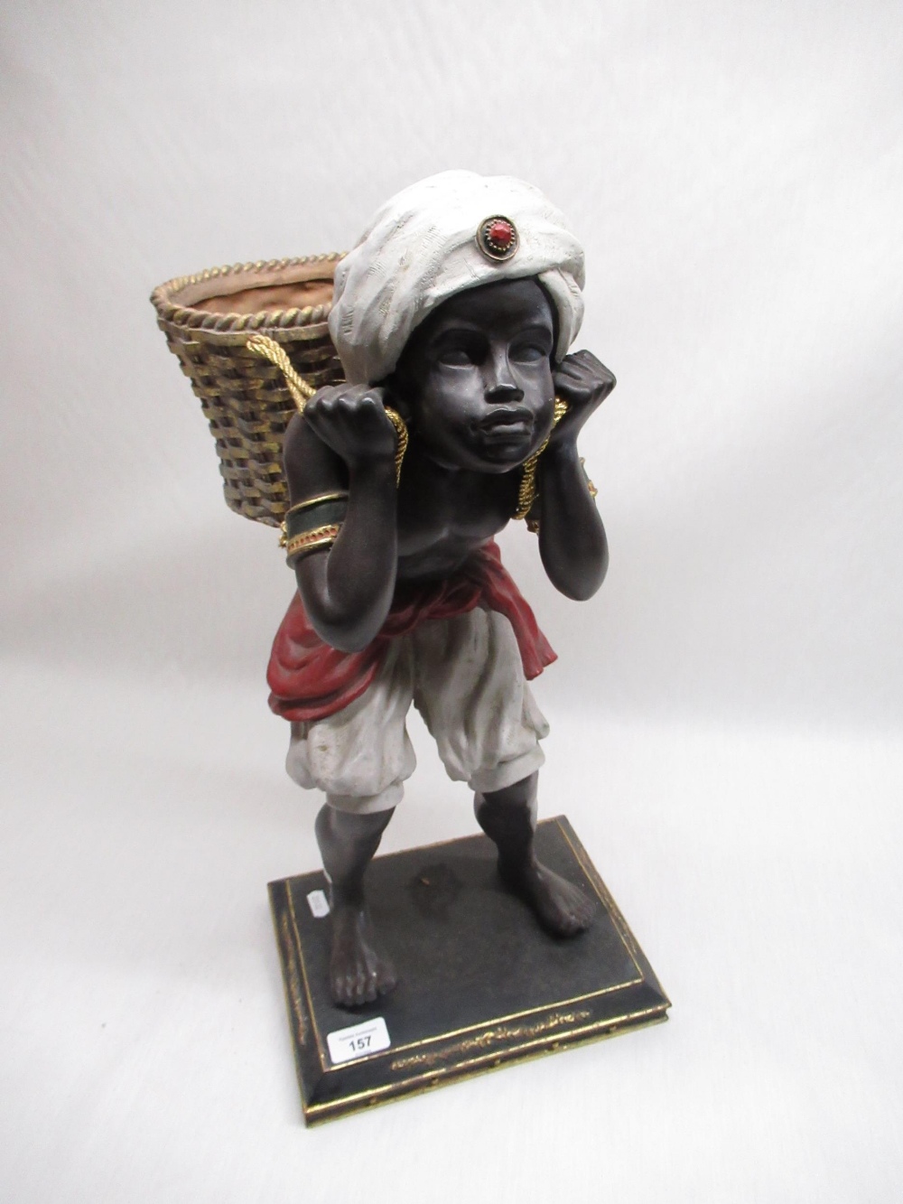 C20th blackamoor figure of a young boy carrying a basket, H55cm