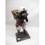 C20th blackamoor figure of a young boy carrying a basket, H55cm