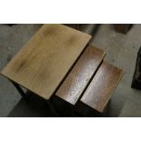 Nest of three oak occasional tables on turned supports