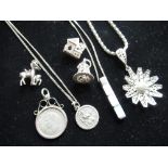 Collection of Sterling silver necklaces and pendants including Geo.VI 3d, bell, bible, church etc