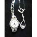 9ct white gold lavalier necklace decorated with round cut diamonds inset in leaf and ribbon shaped