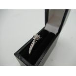 Hallmarked 9ct white gold solitaire ring with twisted claw mount inset with a round cut diamond, SG,