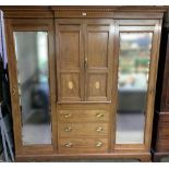 Edwardian inlaid mahogany break front wardrobe with central cupboard and drawers enclosed by