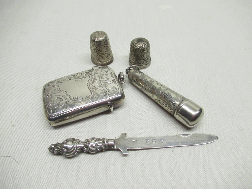 An engraved silver vesta case hallmarked Birm 1902, together with a silver cheroot holder, two